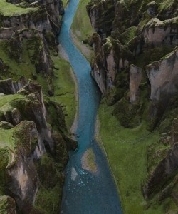 A river running among a green landscape