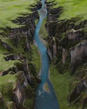 A river running among a green landscape